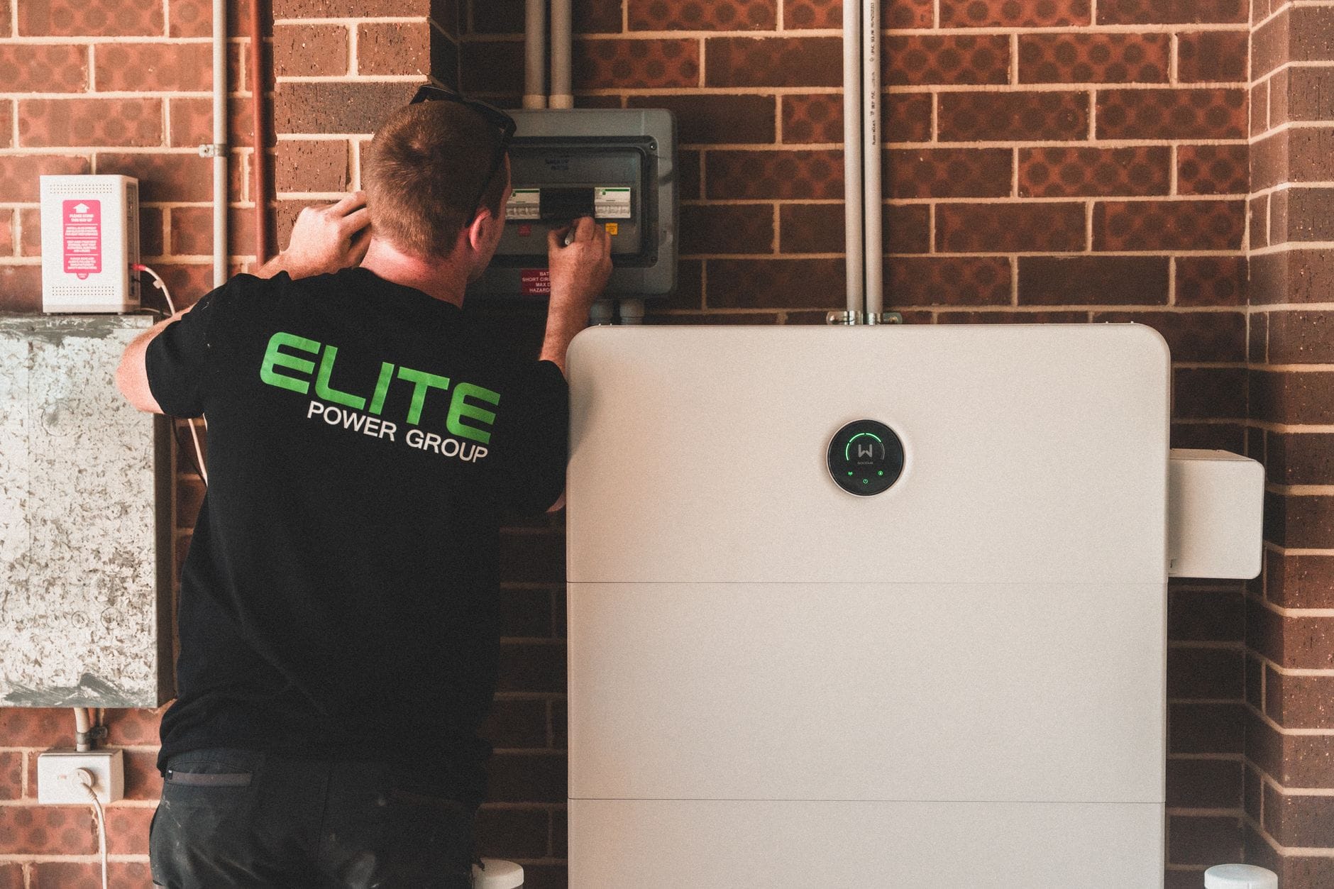 Czy magazyn energii zwiększa autokonsumpcję zimą? Fakty i liczby Elektryk montuje domowy magazyn energii do instalacji fotowoltaicznej